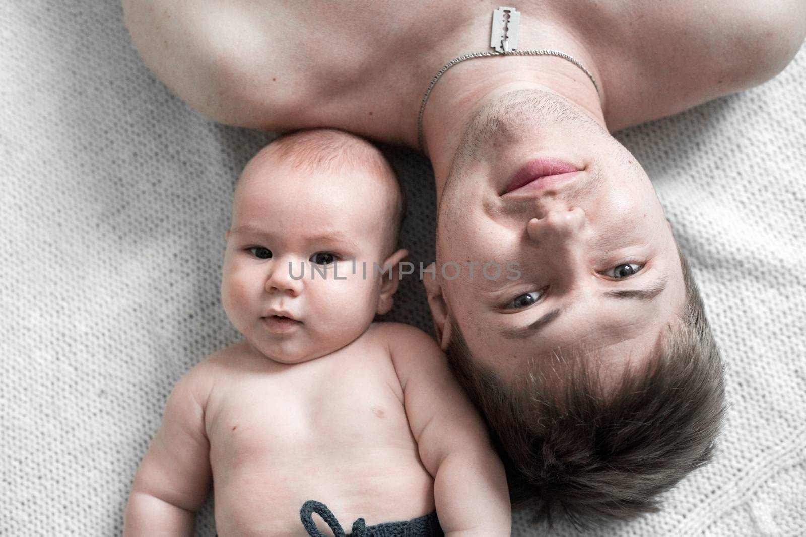 close-up portrait of dad and baby lying on the floor