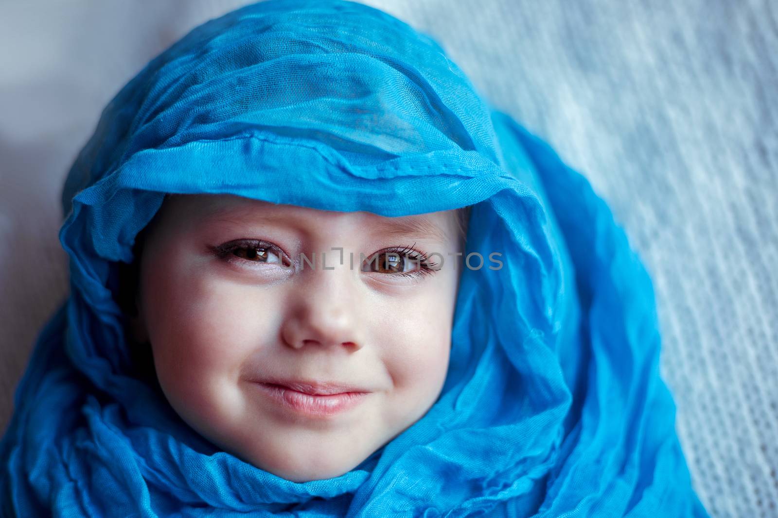 close-up portrait of a girl wrapped In Blanket