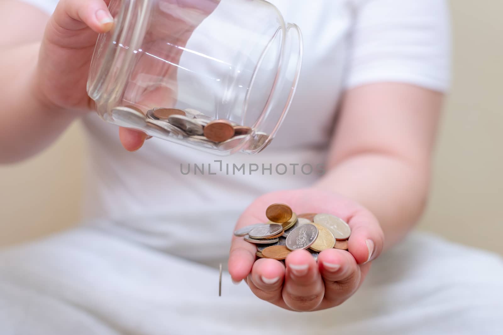 Save money and account banking for finance concept, Hand with coin bottle blurred background