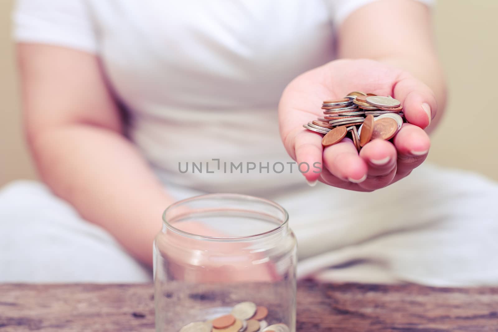 Save money and account banking for finance concept, Hand with coin on blurred background, Vintage style