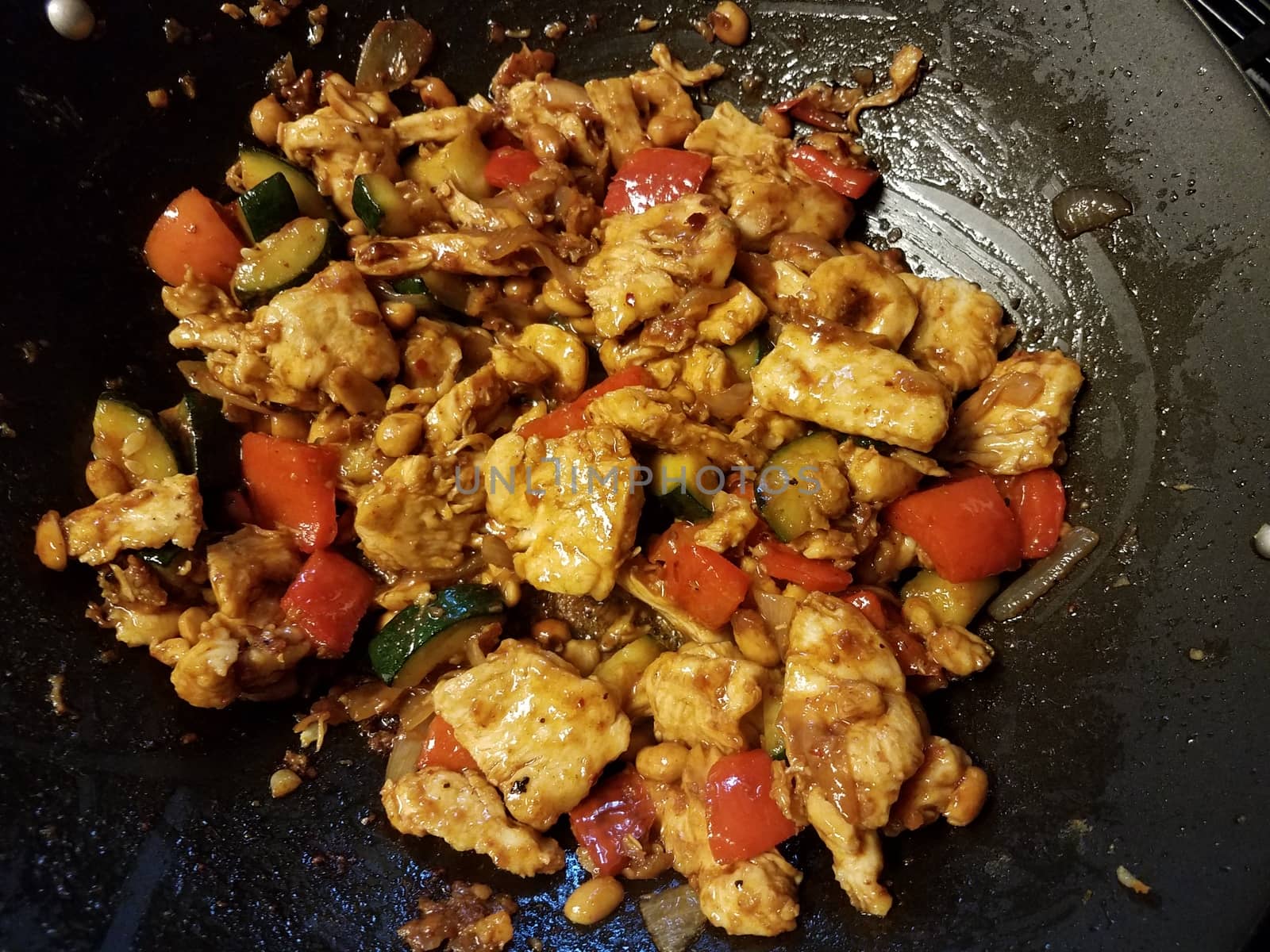 chicken and red pepper and vegetables cooking in wok by stockphotofan1