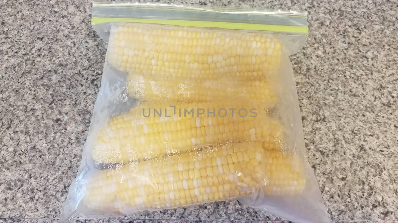 yellow corn in plastic bag on counter by stockphotofan1