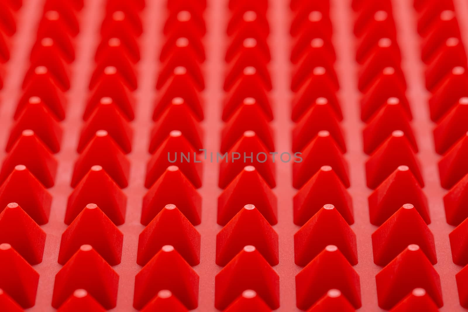 abstract red silicone pyramids mat close-up background.