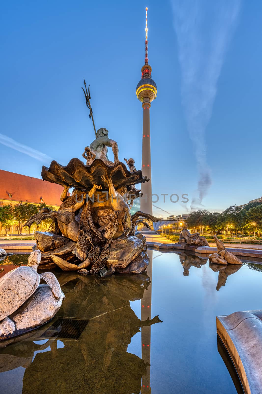 The Television Tower and the Neptune fountain at Alexanderplatz in Berlin at dawn
