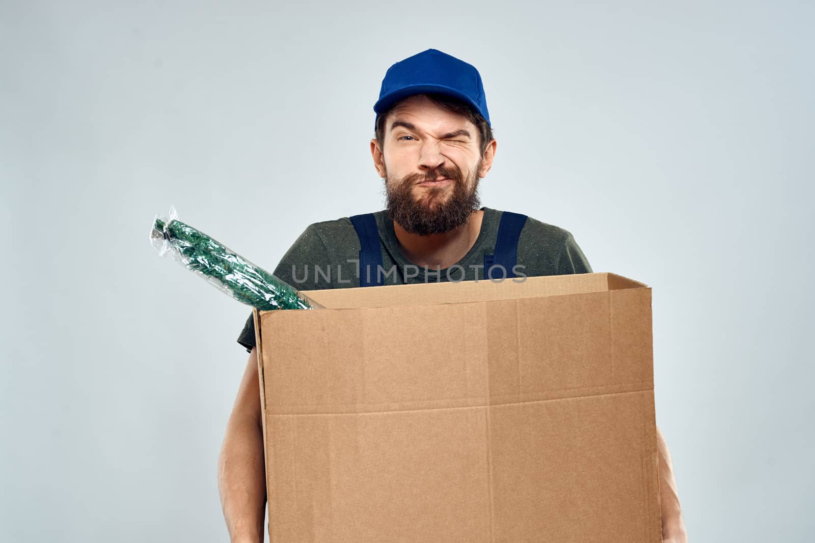 Male worker loading delivery boxes in hands packing lifestyle by SHOTPRIME
