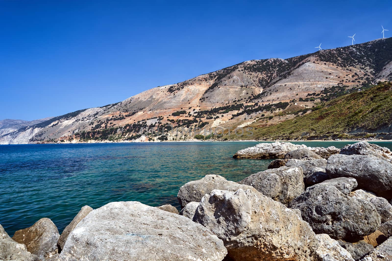 Boulders and windmills of the mountainous sea shore on the island of Kefalonia in Greece