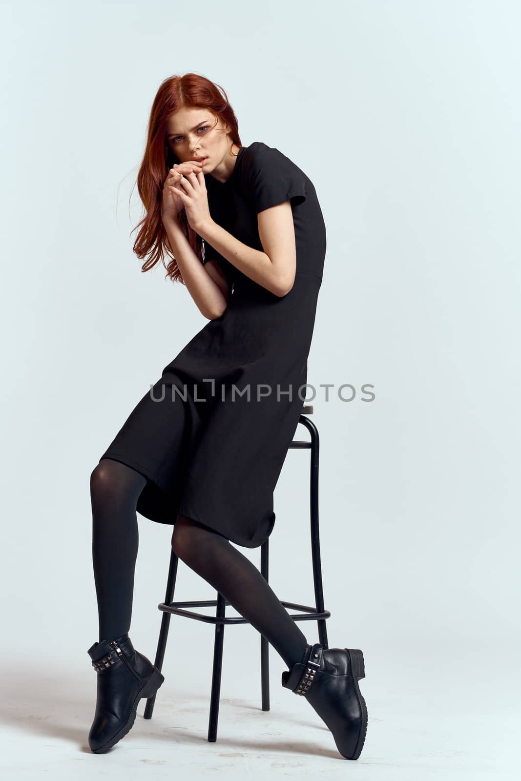 woman high chair indoors full length black dress red hair model boots by SHOTPRIME