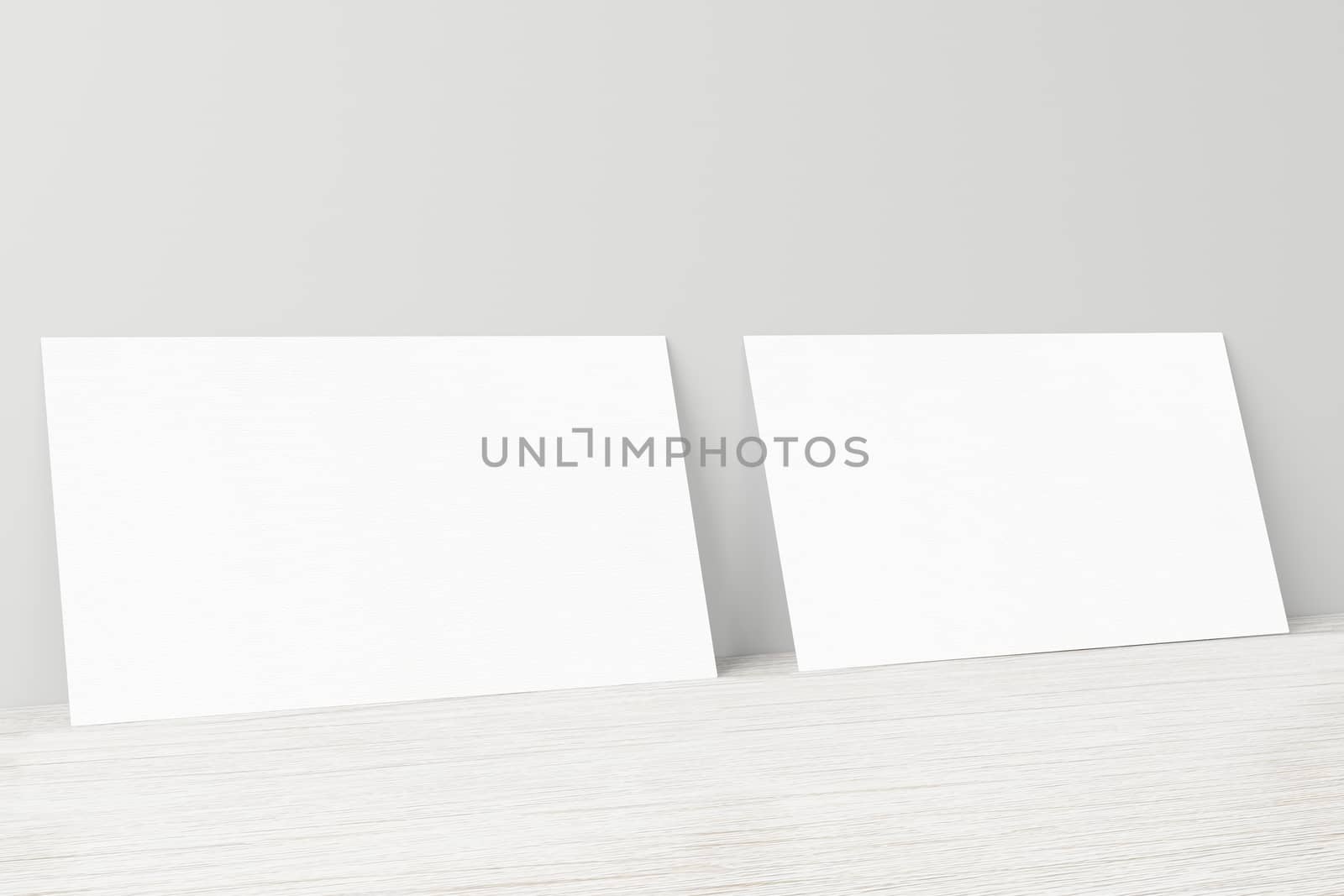 Mockup of two horizontal business cards at white textured background.