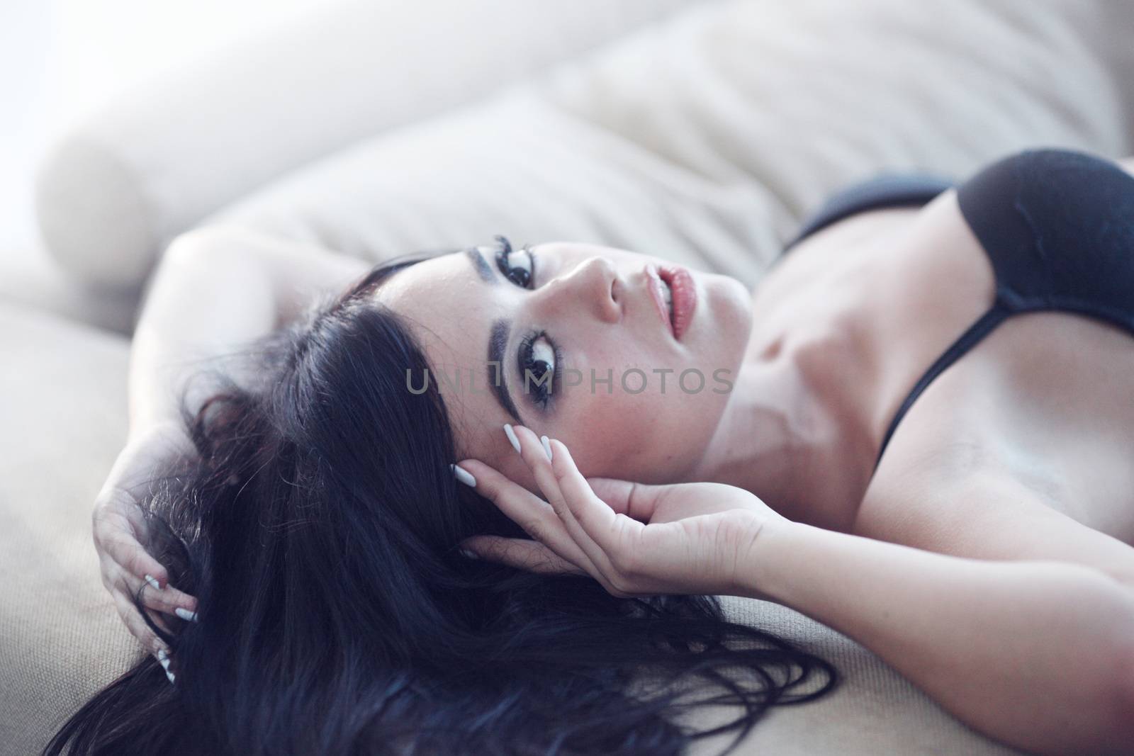 Woman in black lingerie on sofa by ALotOfPeople