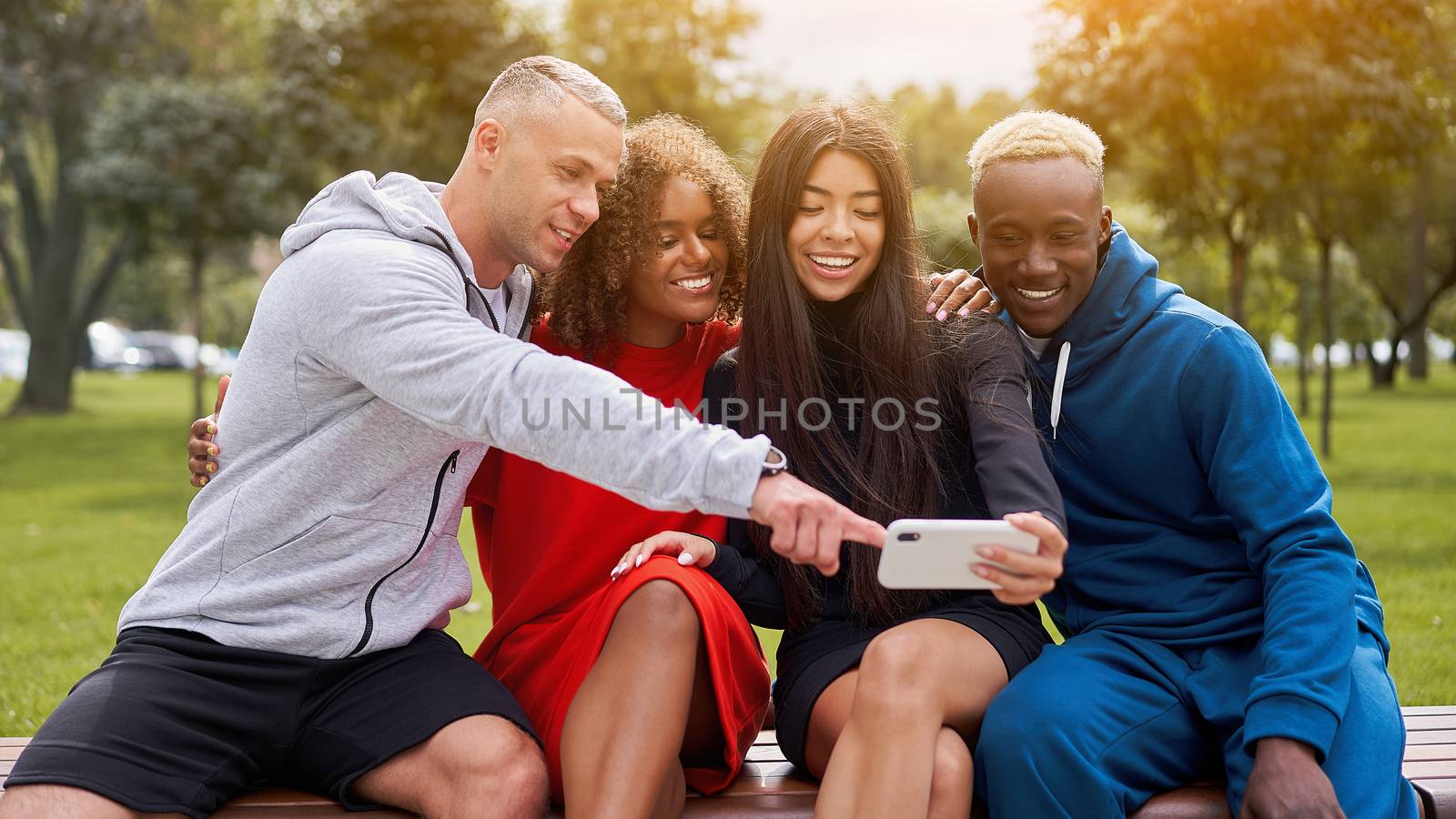 Multi ethnic friends outdoor. Diverse group people Afro american asian caucasian spending time together by andreonegin