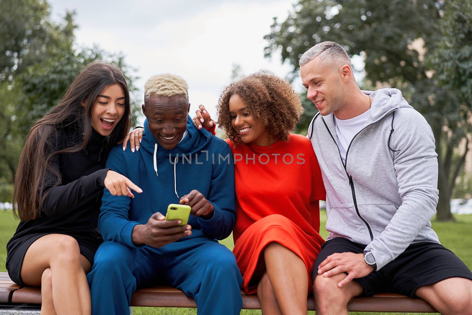 Multi ethnic friends outdoor looking smartphone screen. Diverse group people Afro american asian caucasian spending time together Multiracial male female student meeting outdoors