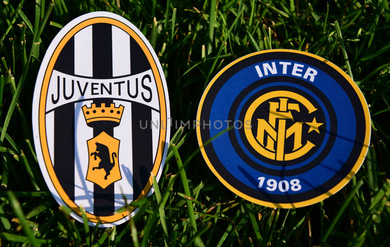 September 6, 2019, Turin, Italy. Emblems of Italian football clubs Juventus Turin and Internazionale on the green grass of the lawn.