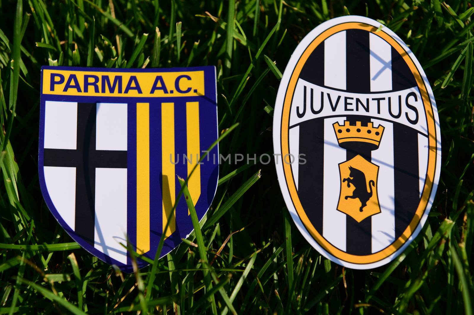 September 6, 2019, Turin, Italy. Emblems of Italian football clubs Juventus Turin and Parma on the green grass of the lawn.
