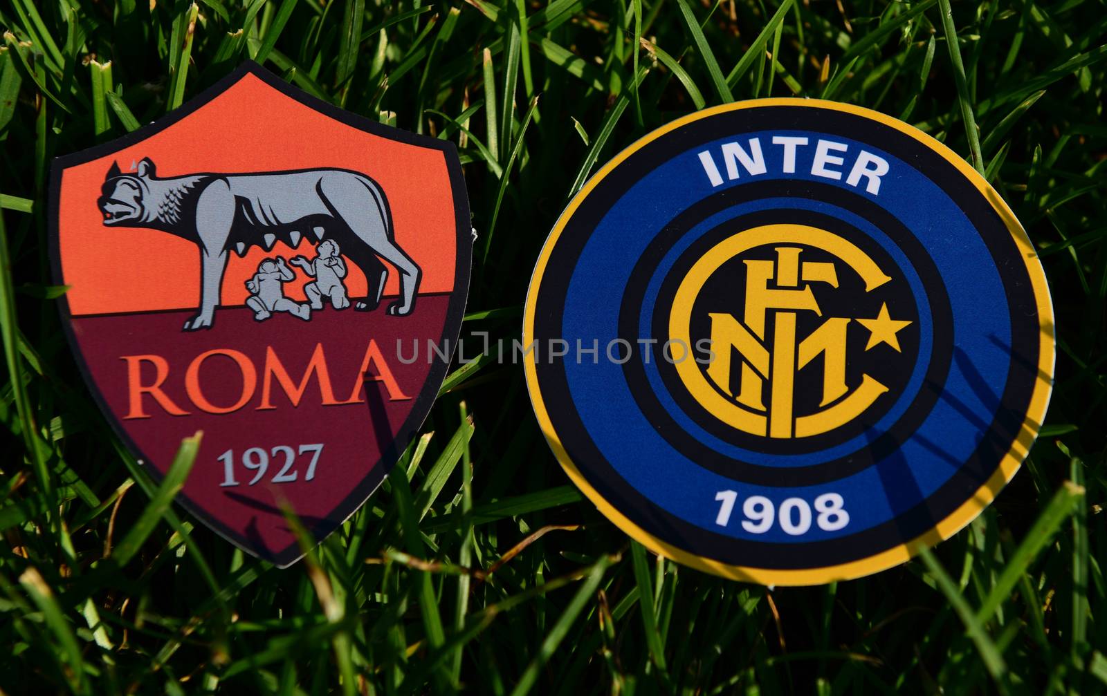 September 6, 2019, Turin, Italy. Emblems of Italian football clubs Roma and Internazionale on the green grass of the lawn.
