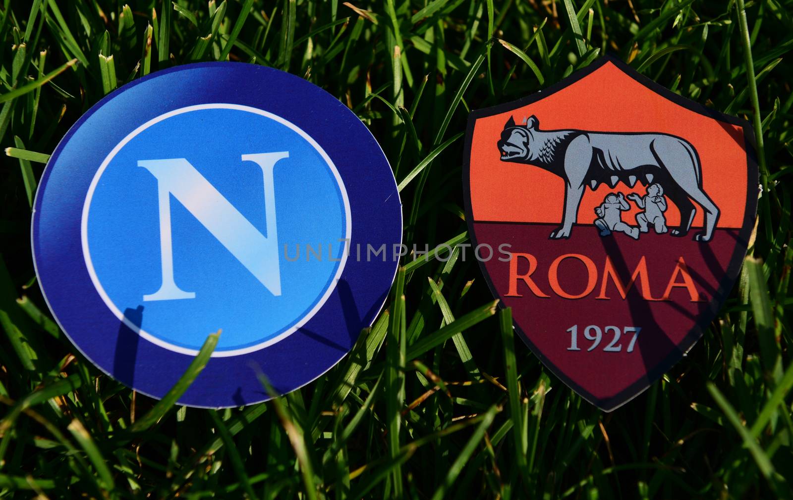 September 6, 2019, Turin, Italy. Emblems of Italian football clubs Roma and Napoli Naples on the green grass of the lawn.