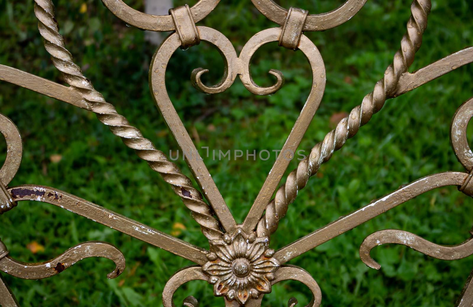 Forged elements on a garden bench in the shape of a heart.Garden wrought iron furniture in the garden by lapushka62