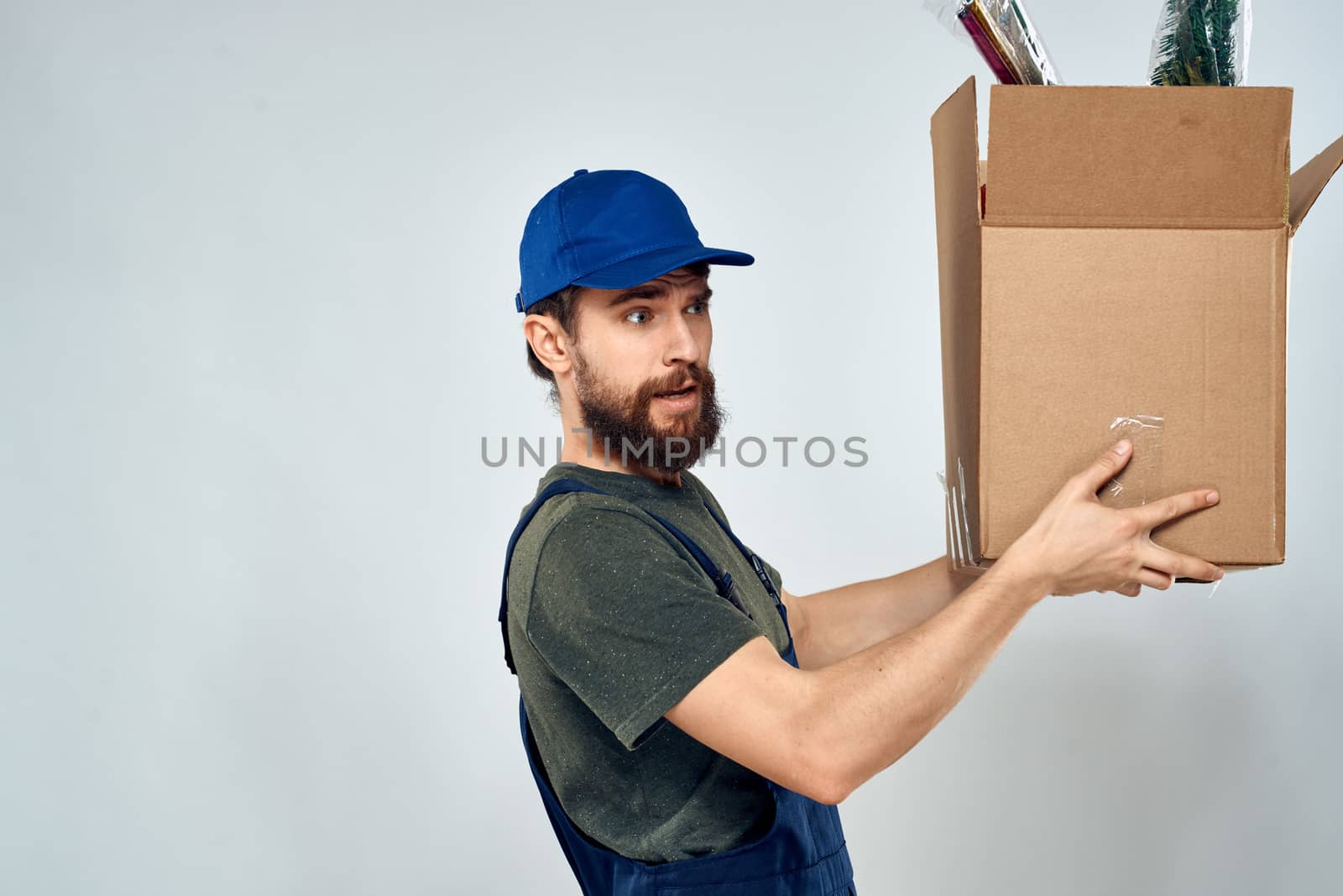 Male worker loading delivery boxes in hands packing lifestyle. High quality photo