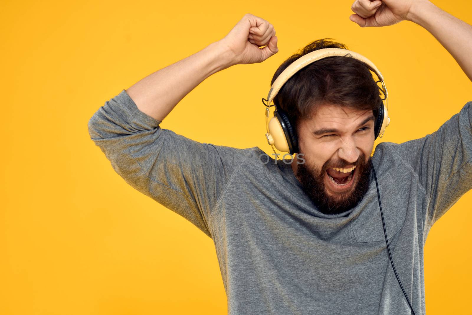 Man with headphones music lifestyle lifestyle technology yellow background. High quality photo