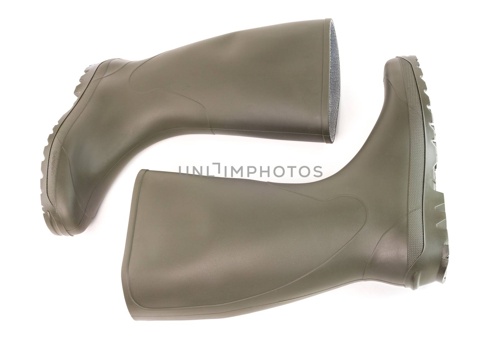 A pair of clean green rubber boots laying down isolated on white background. Front view.