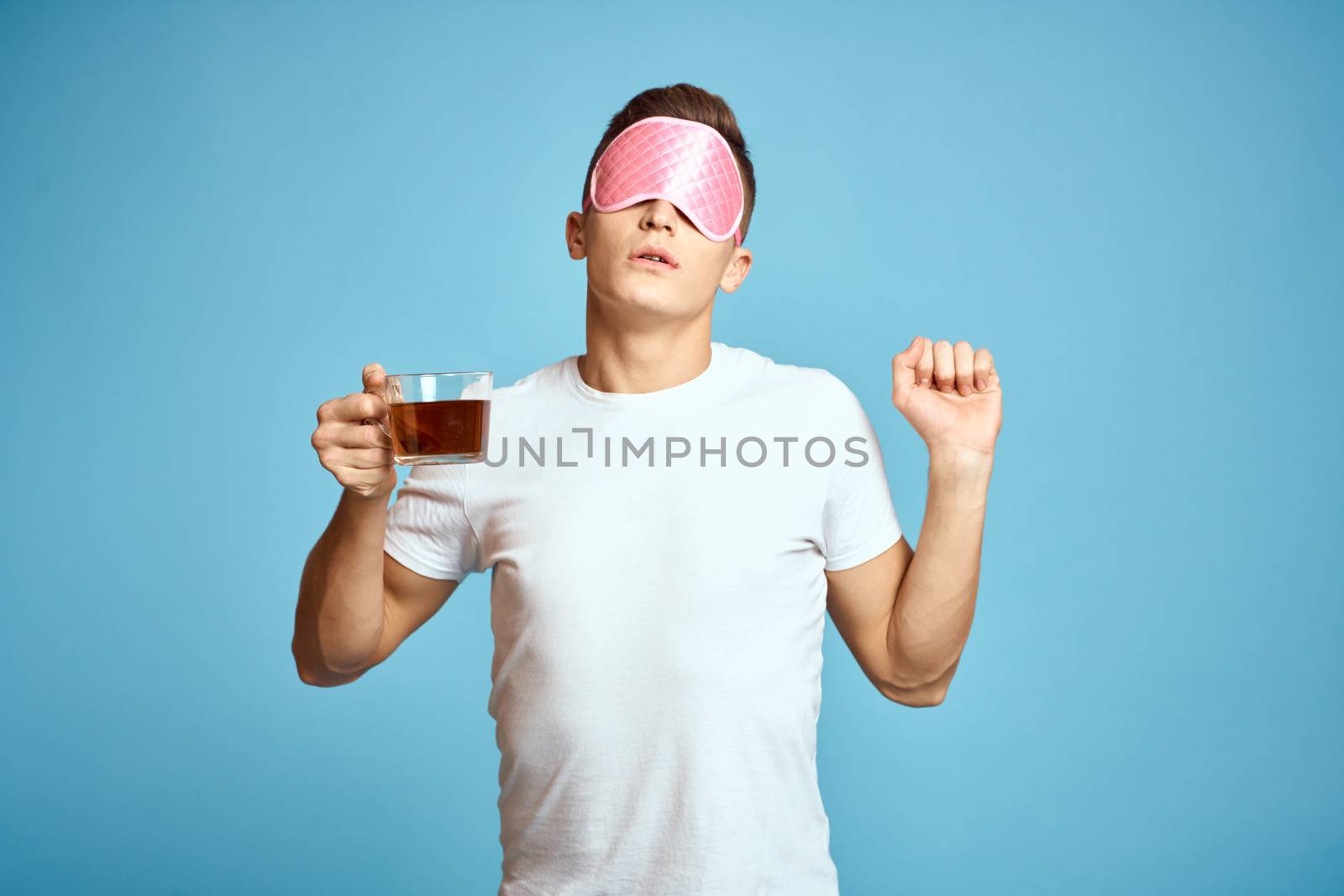 man with pink sleep mask and cup of tea drink cheerfulness model breakfast by SHOTPRIME