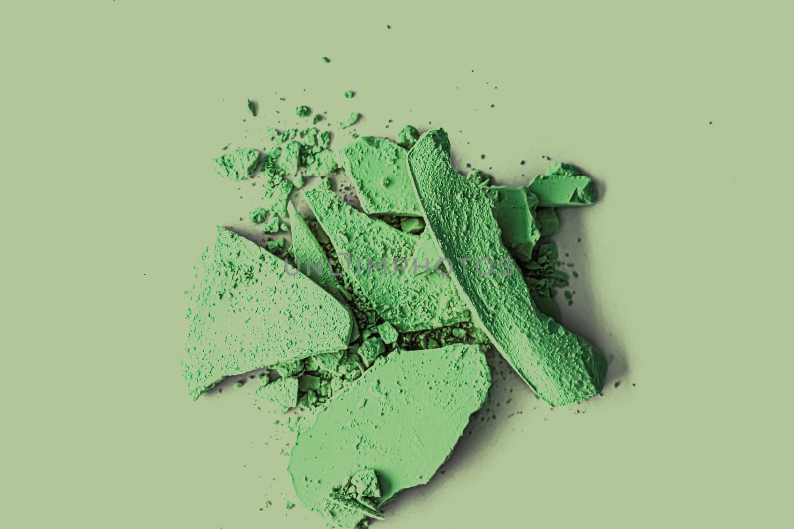 Green eye shadow powder as makeup palette closeup, crushed cosmetics and beauty textures