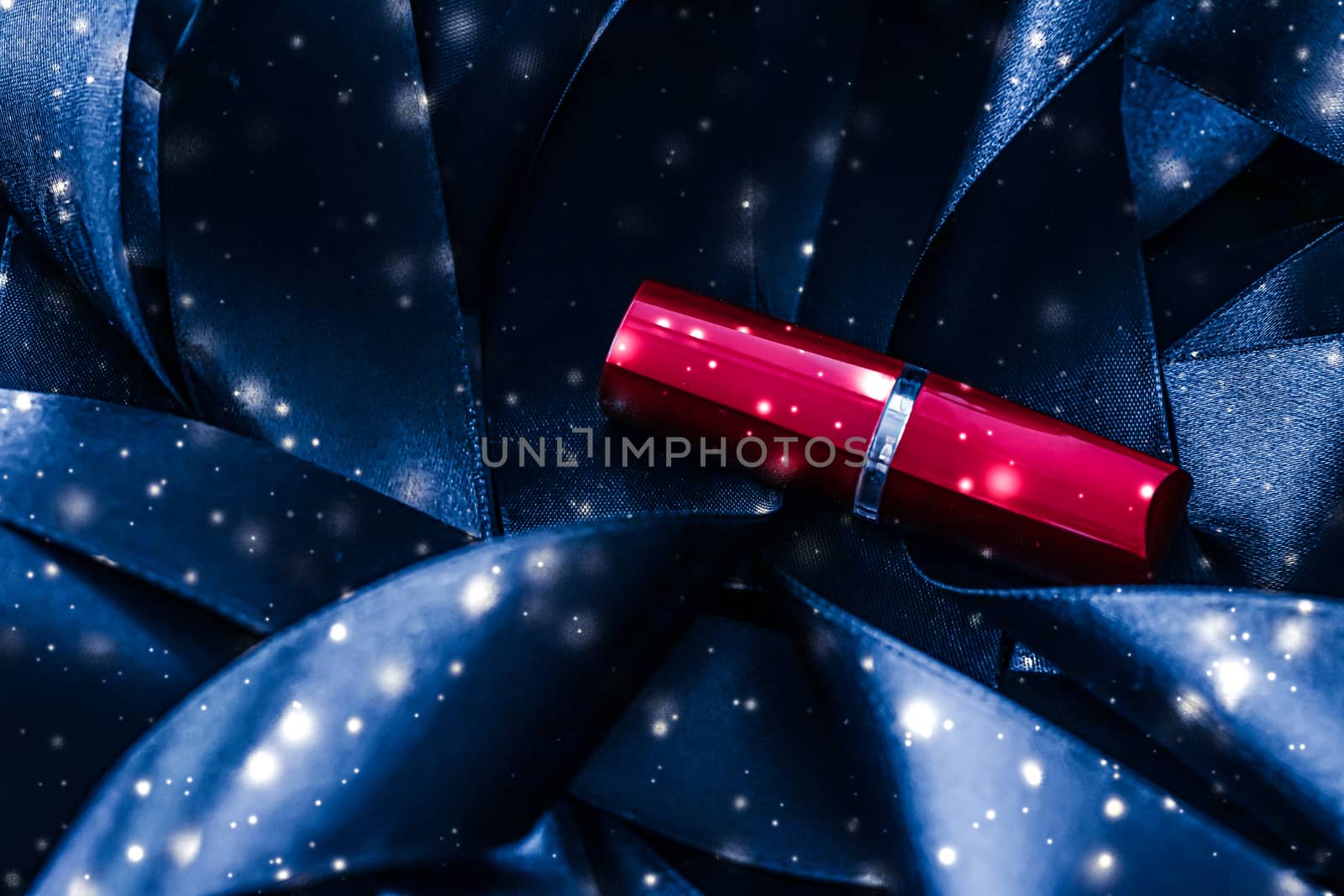 Red lipstick on blue silk and shiny glitter background, luxury make-up and beauty cosmetics