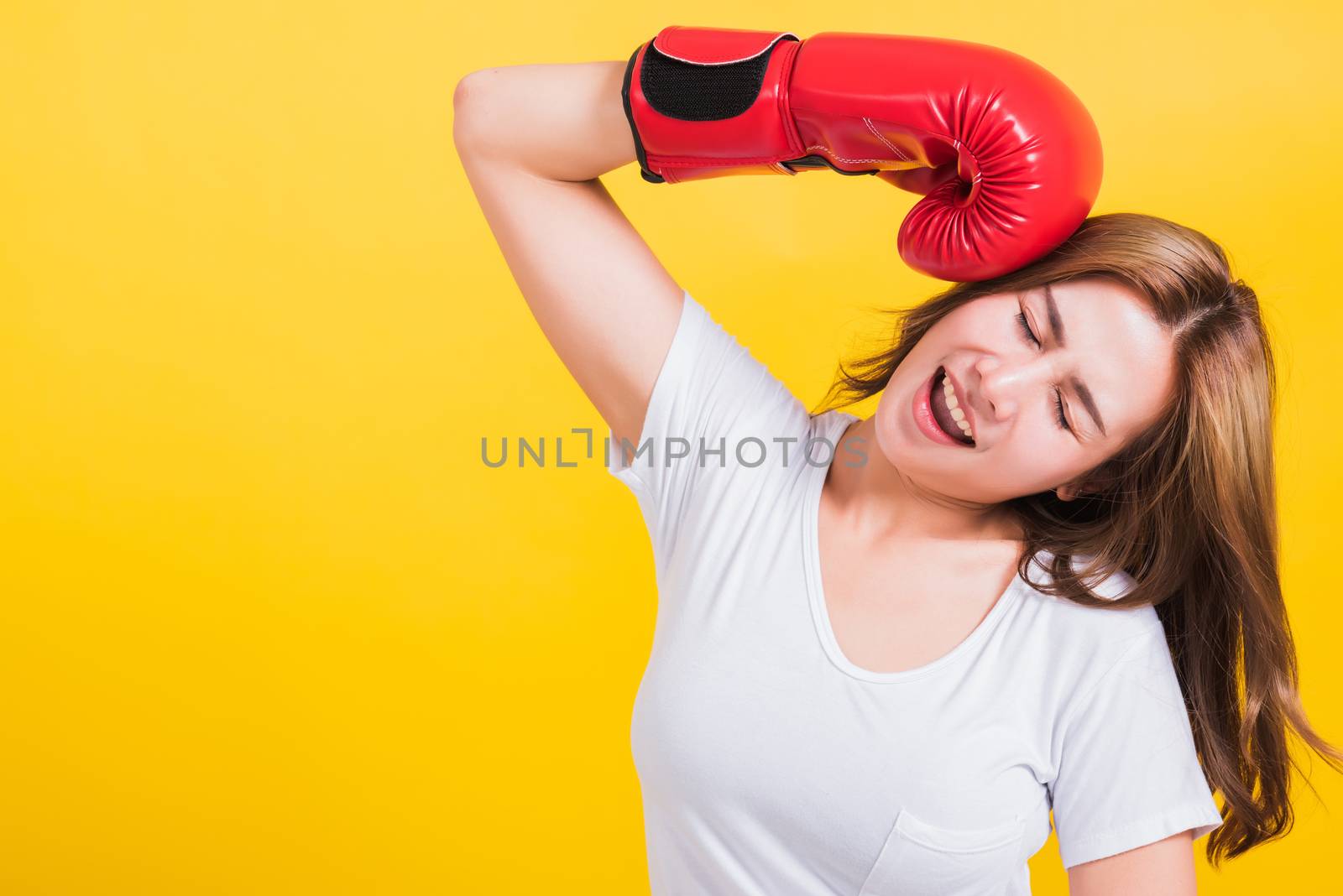 Young woman standing smile in boxing gloves by Sorapop