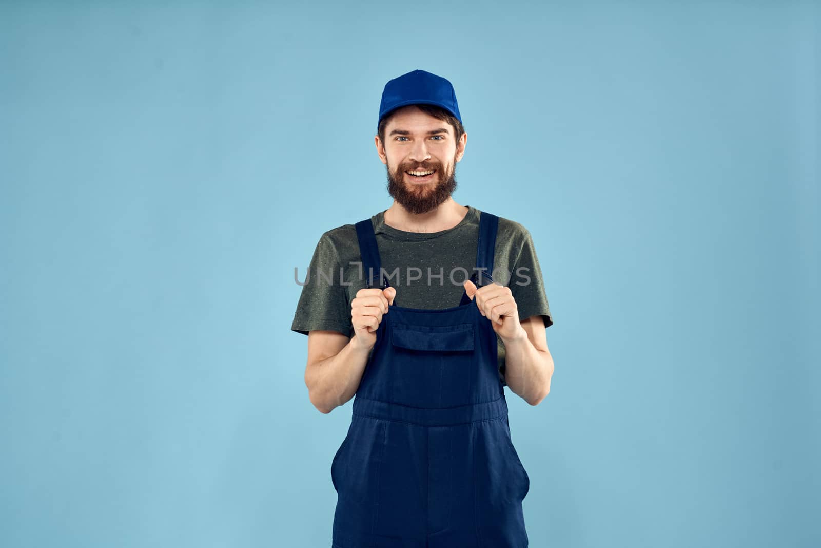 man in work uniform uniform professional work lifestyle delivery service blue background. High quality photo