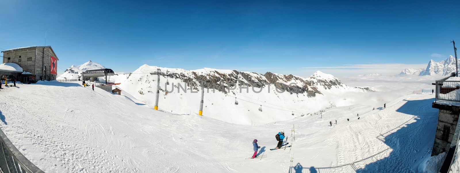 Skier skiing downhill in high mountains in Piz Gloria at Switzerland