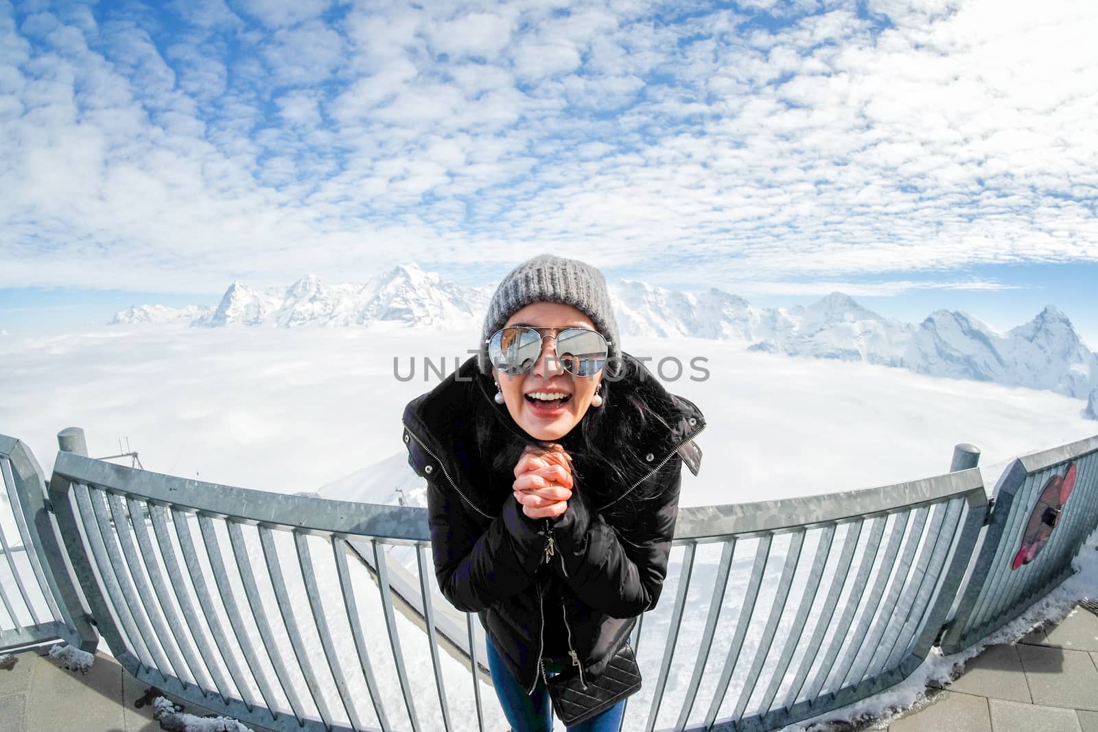 Young Woman Tourist at the Schilthorn in Switzerland with a magn by Surasak