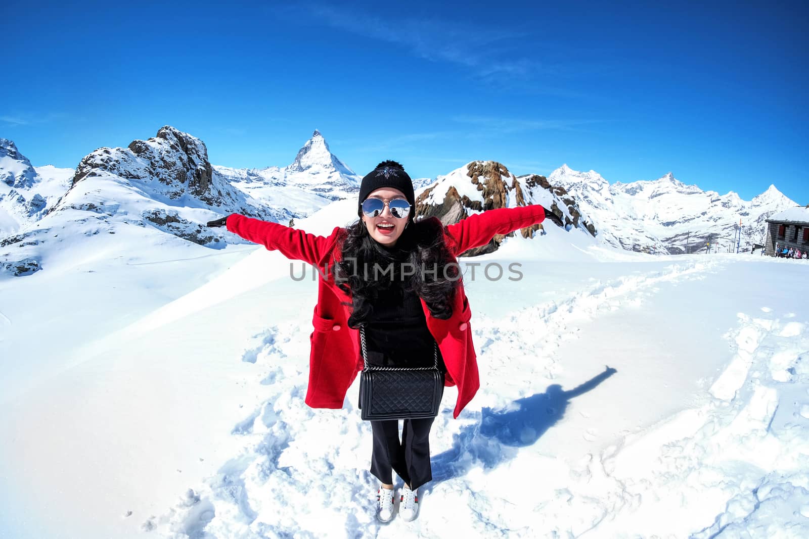 Young Woman Tourists see beautiful view of snow mountain Matterh by Surasak