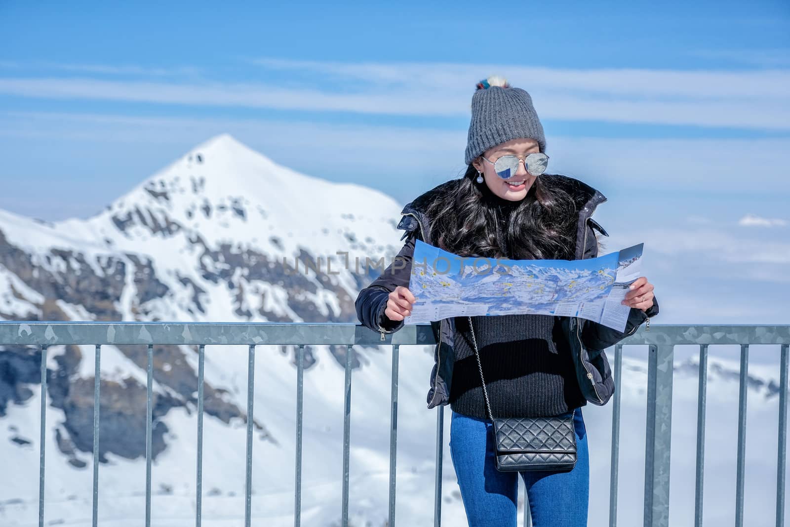 Young female tourist looking map at the Schilthorn in Switzerlan by Surasak