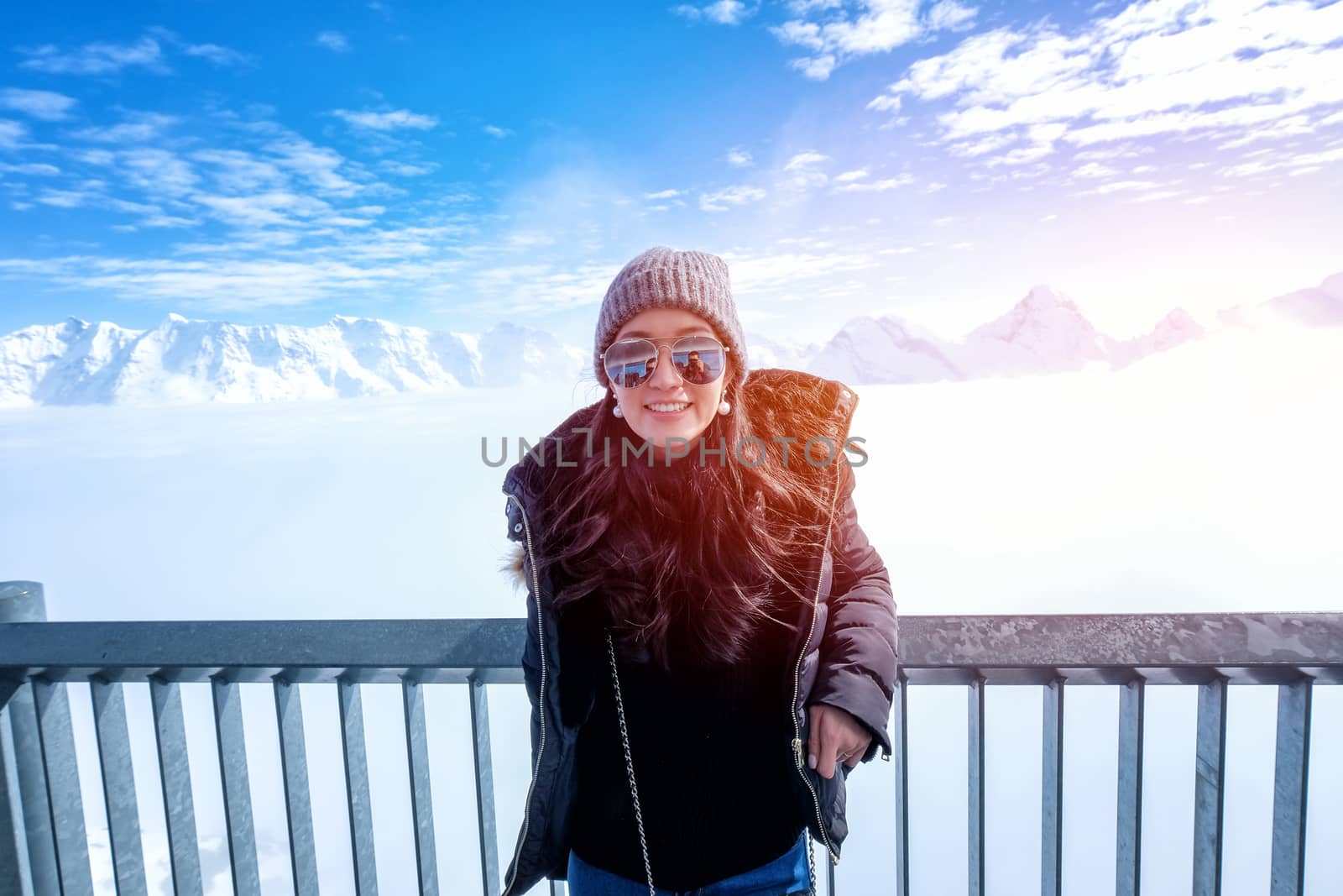 Young Woman Tourist at the Schilthorn in Switzerland with a magn by Surasak