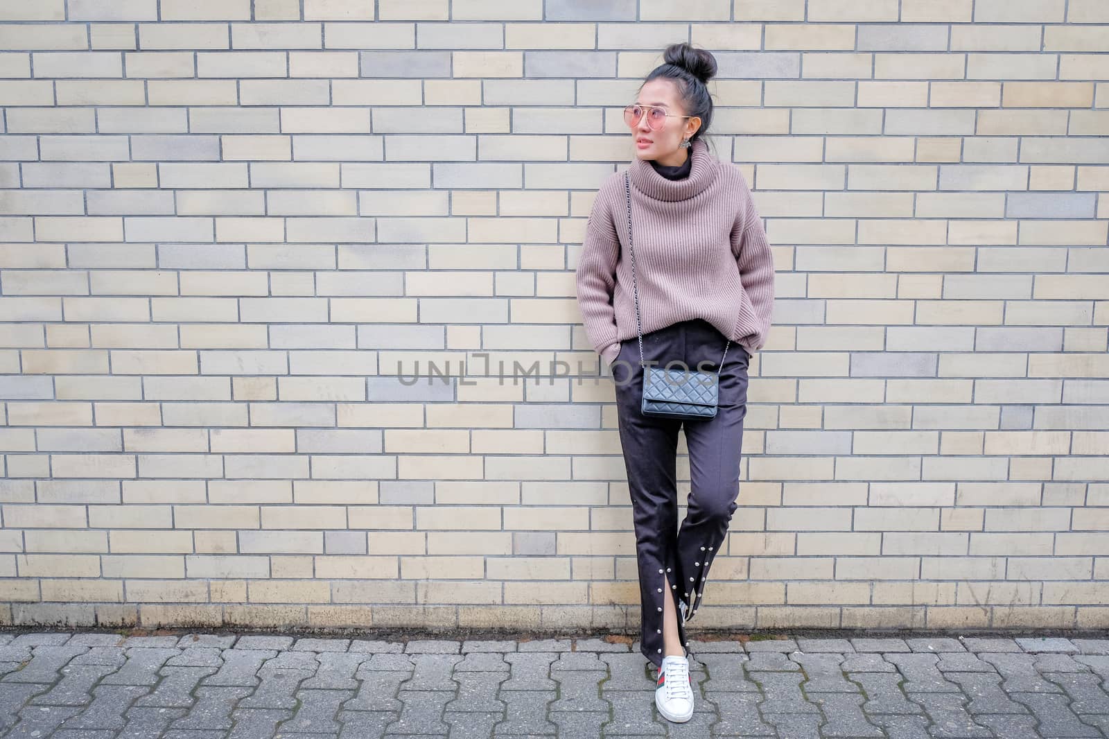 Asian woman smiling on pastel background 