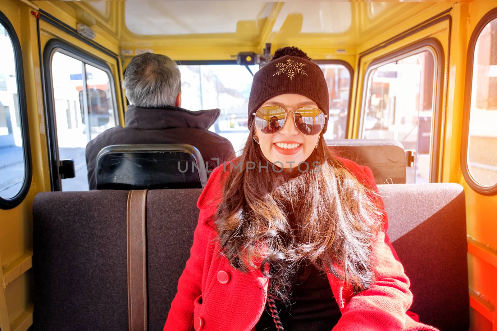 Close up portrait of happy tourist young asian woman sitting in yellow Taxi car 