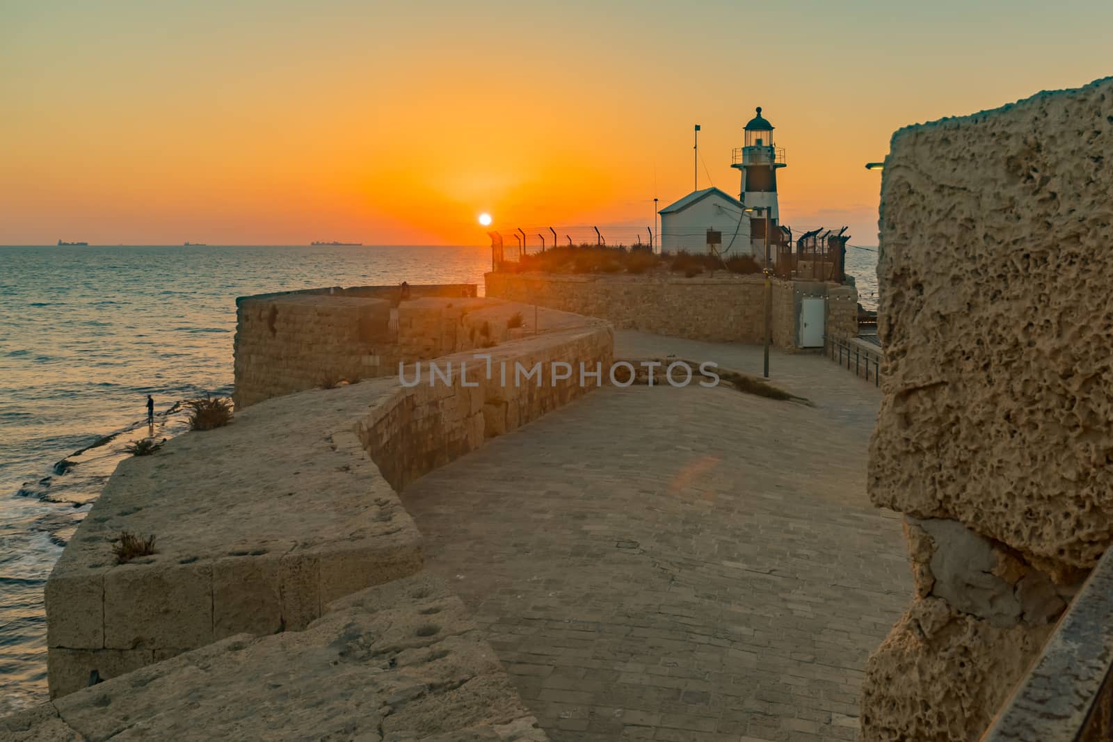 Sunset view of the lighthouse, in the old city of Acre (Akko), Israel