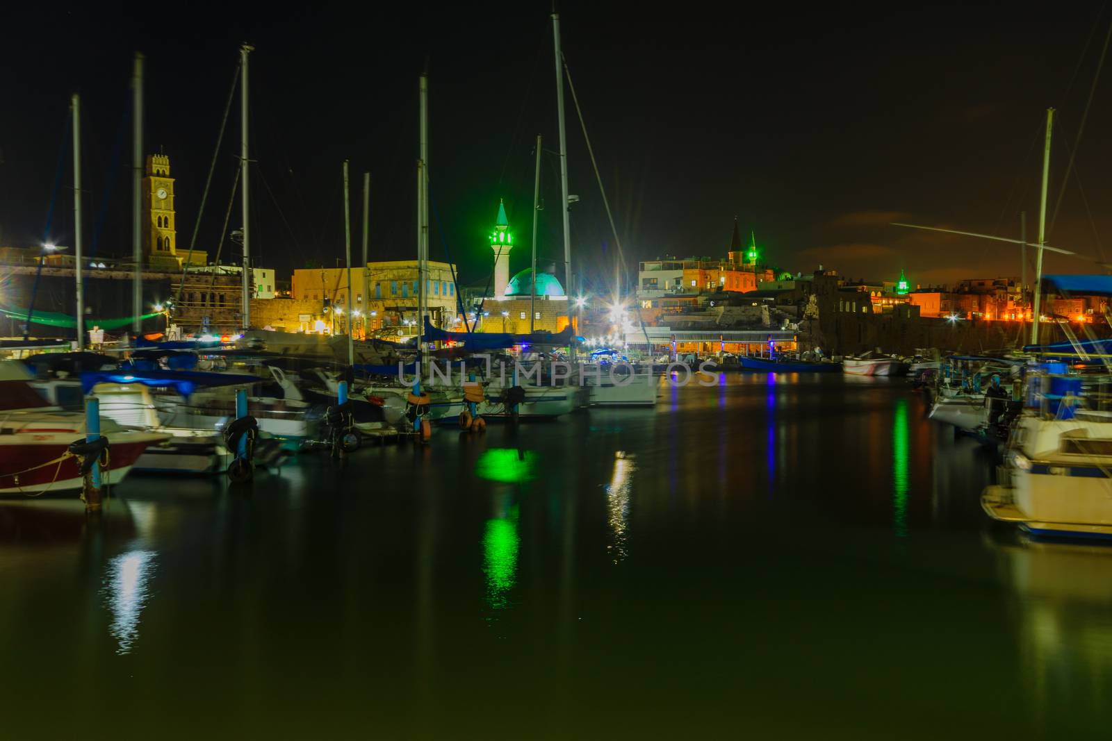 Evening view of the fishing port and other monuments, in the old city of Acre (Akko), Israel