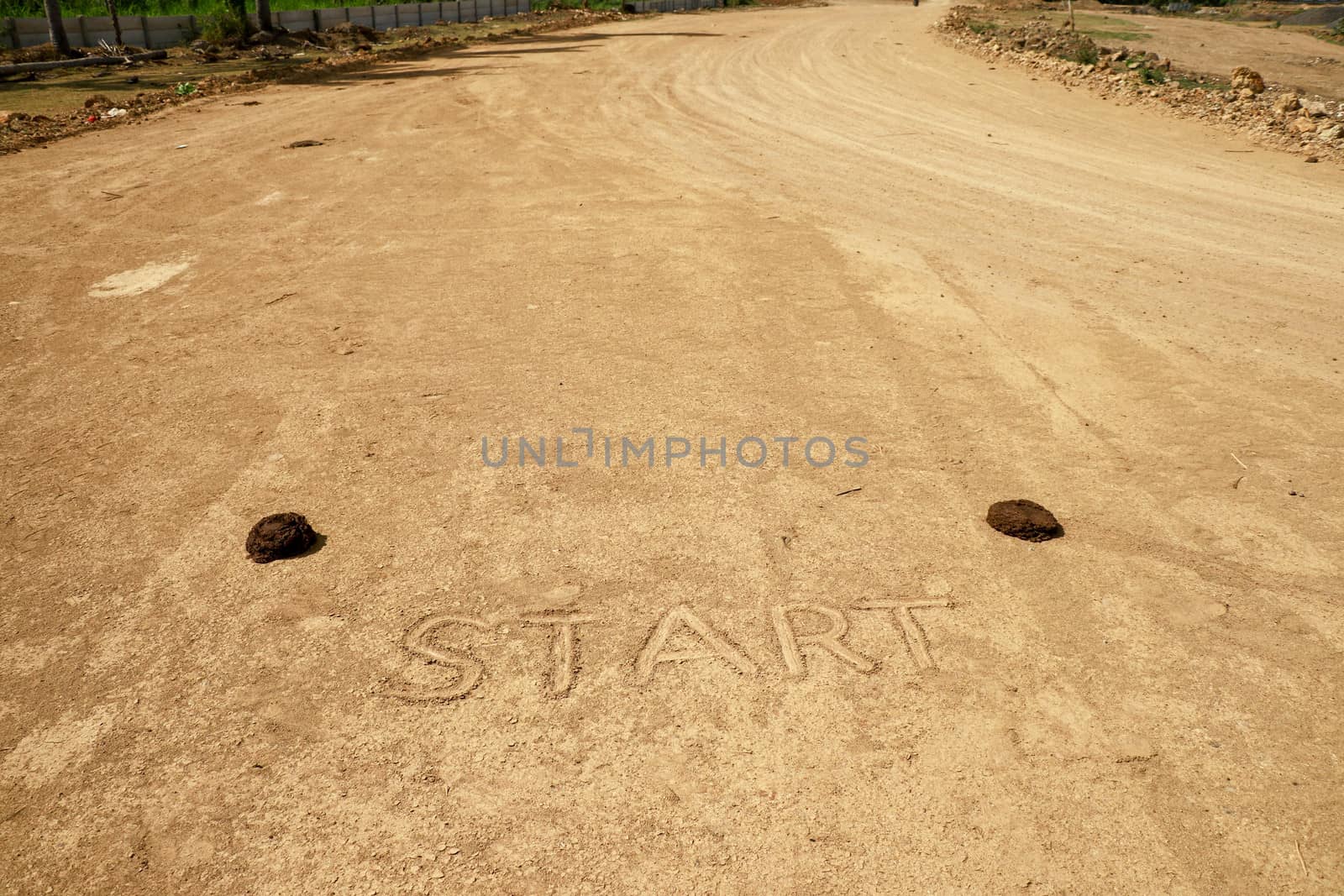 Sunny start line racing background on sand. Sign start on the race track. Moto GP Mandalika racing circuit under construction, West Nusa Tenggara, Lombok, IndonesiaRailway under construction.