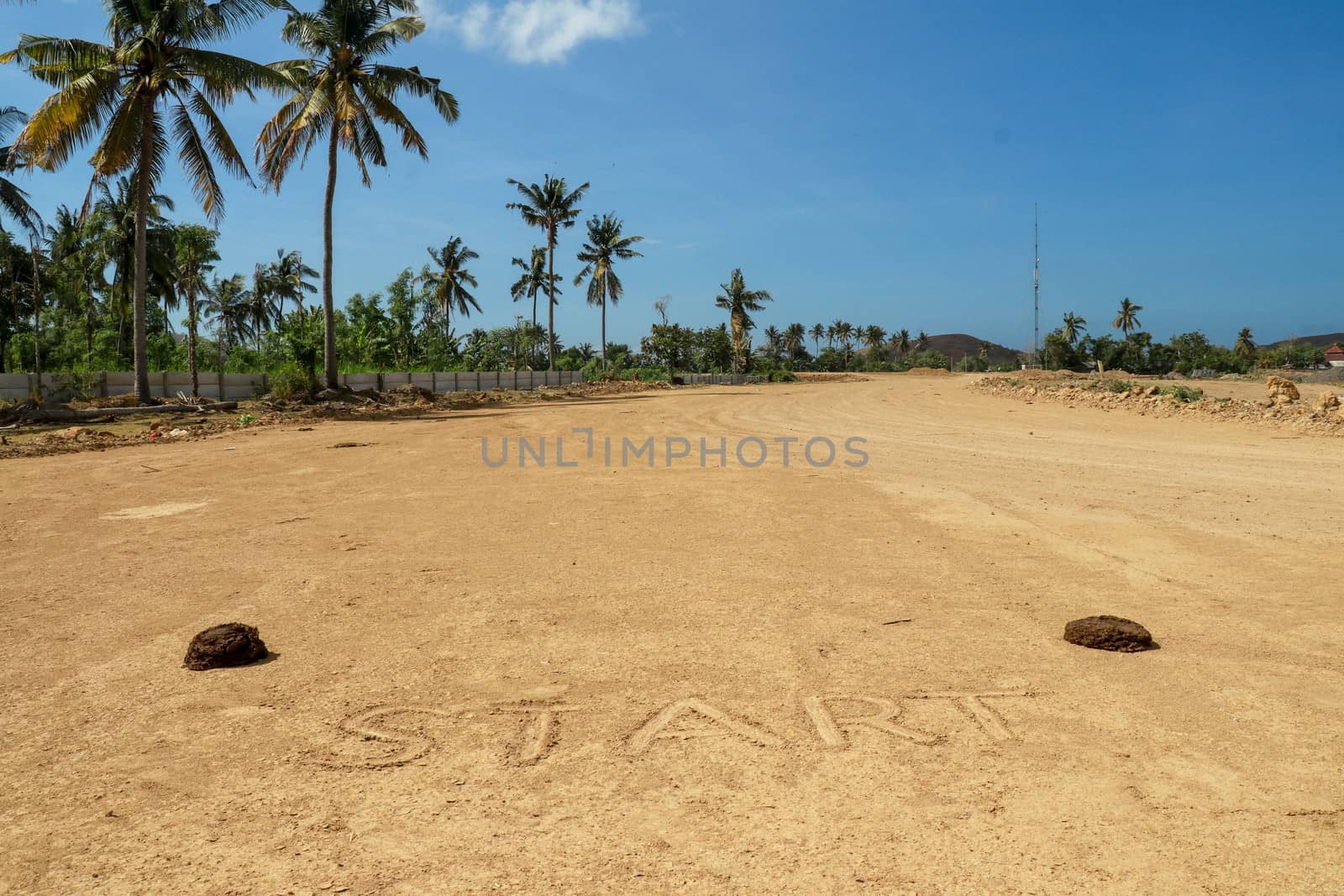 Sunny start line racing background on sand. Sign start on the race track. Moto GP Mandalika racing circuit under construction, West Nusa Tenggara, Lombok, IndonesiaRailway under construction.