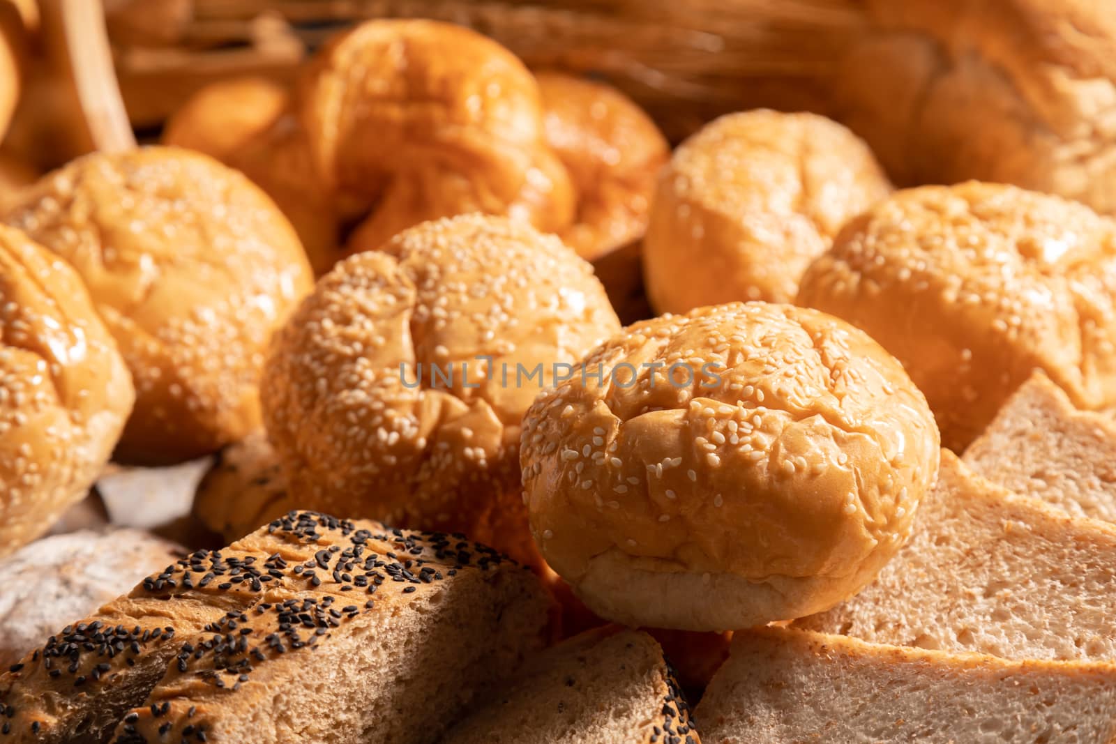 Close-up A variety of sesame buns put together on the table with sunlight.