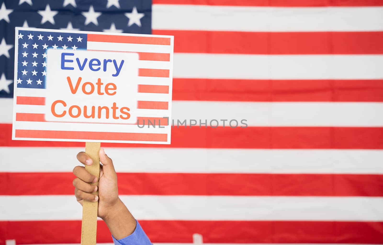 Hands Holding Every Vote counts sign board with US Flag as Background with copy space - Concept of voter rights and US election. by lakshmiprasad.maski@gmai.com