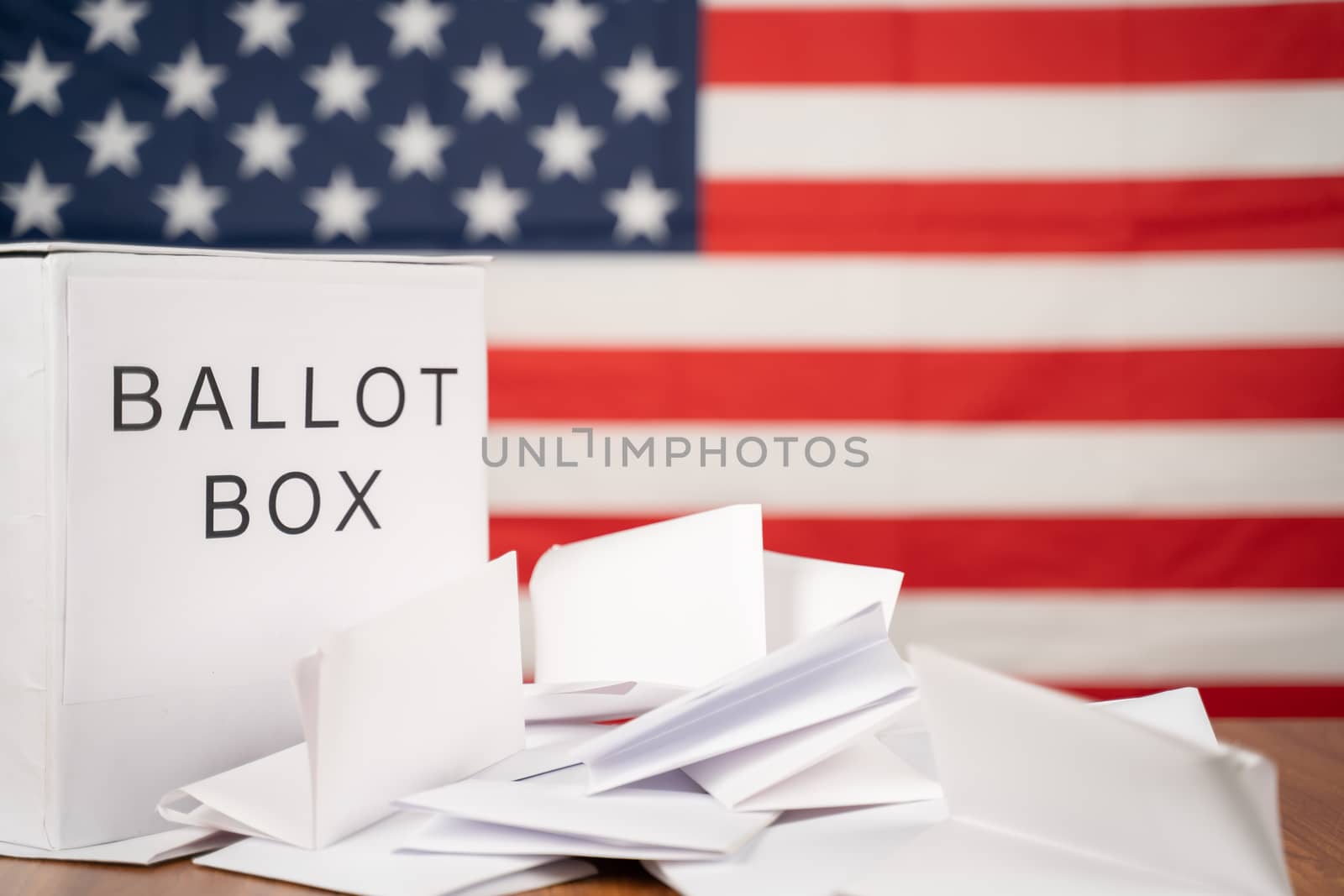 Ballot Box with votes on table before counting with US flag as background concept of Ballot or vote Counting after US election by lakshmiprasad.maski@gmai.com