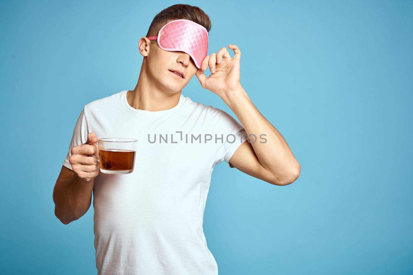 man with pink sleep mask and cup of tea drink cheerfulness model breakfast by SHOTPRIME