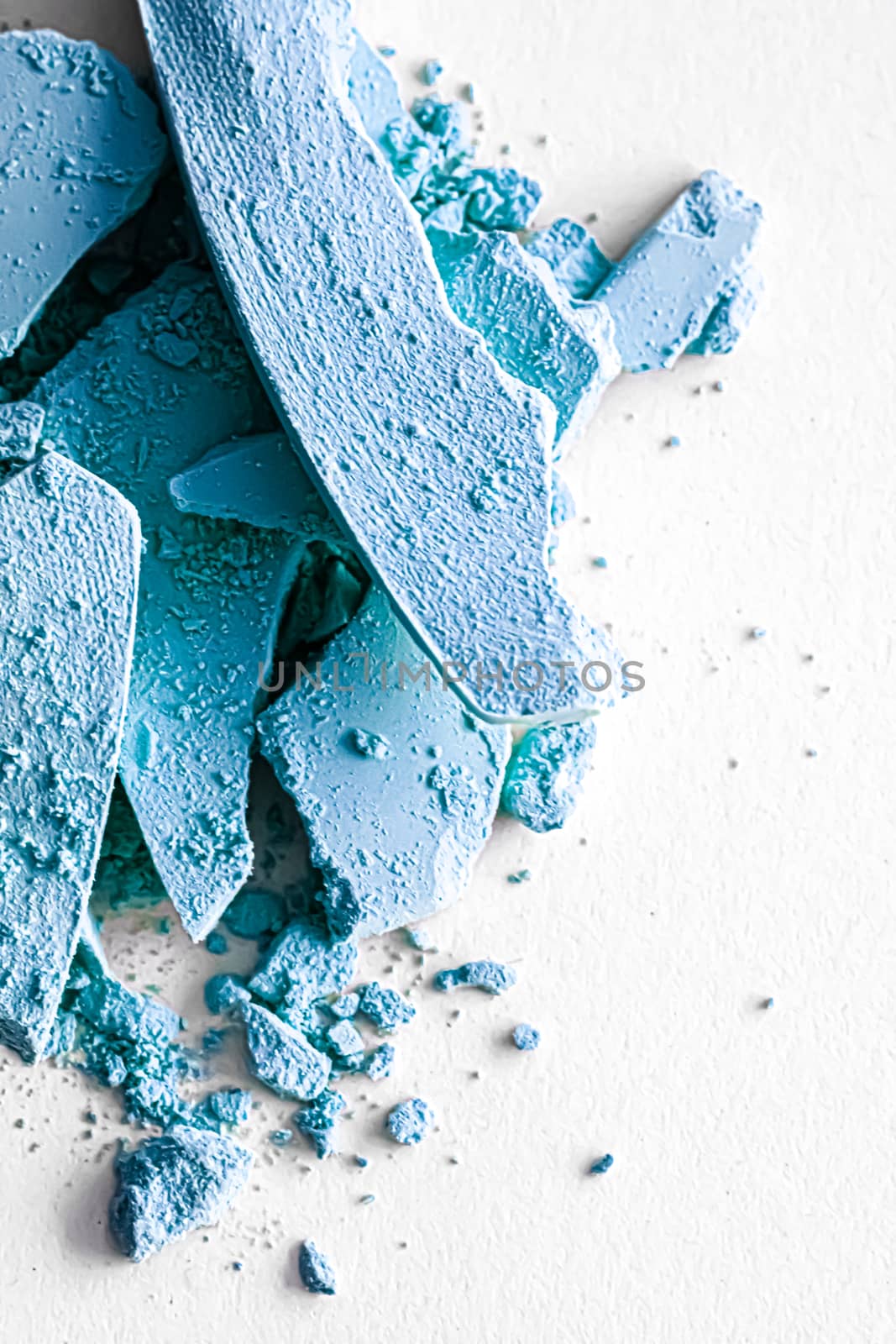 Blue eye shadow powder as makeup palette closeup isolated on white background, crushed cosmetics and beauty texture by Anneleven