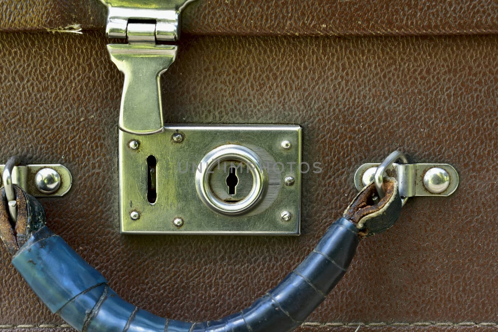 open lock and handle of an old suitcase front view