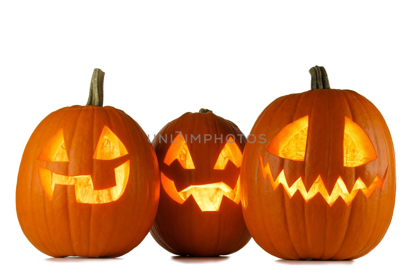 Three glowing cute Halloween Pumpkins isolated on white background