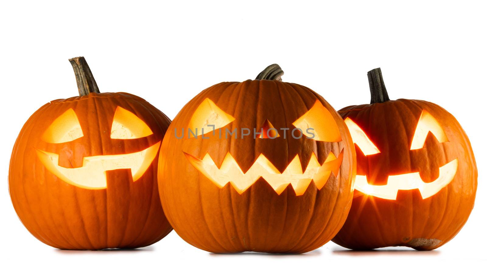 Three glowing cute Halloween Pumpkins isolated on white background