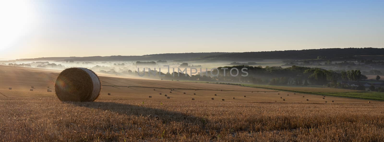 straw bales in early morning light on countryside of french normandy near calais and boulogne in parc naturel des caps et marais dopale