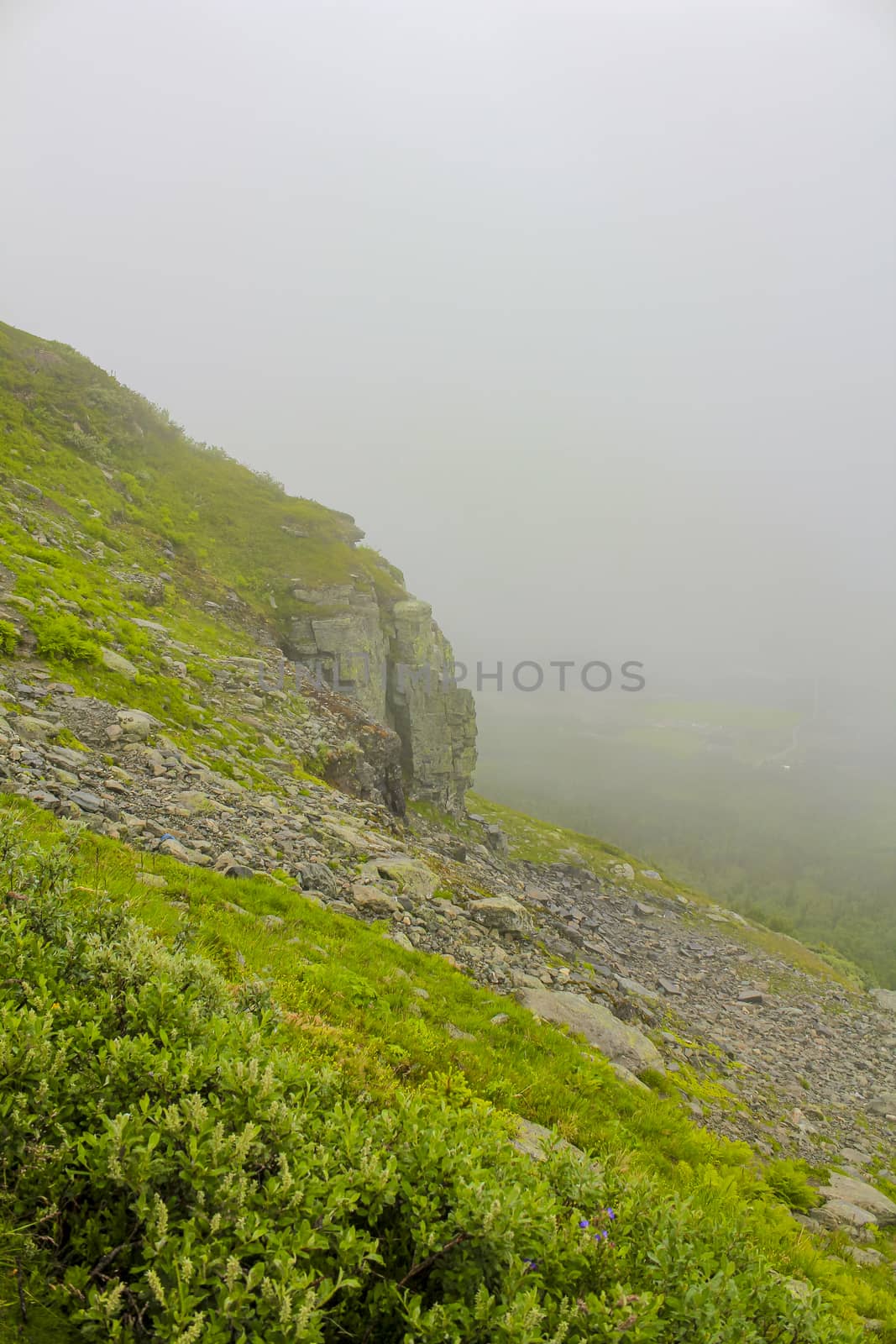 Fog, clouds, rocks and cliffs on Veslehødn Veslehorn mountain in Hemsedal, Norway.