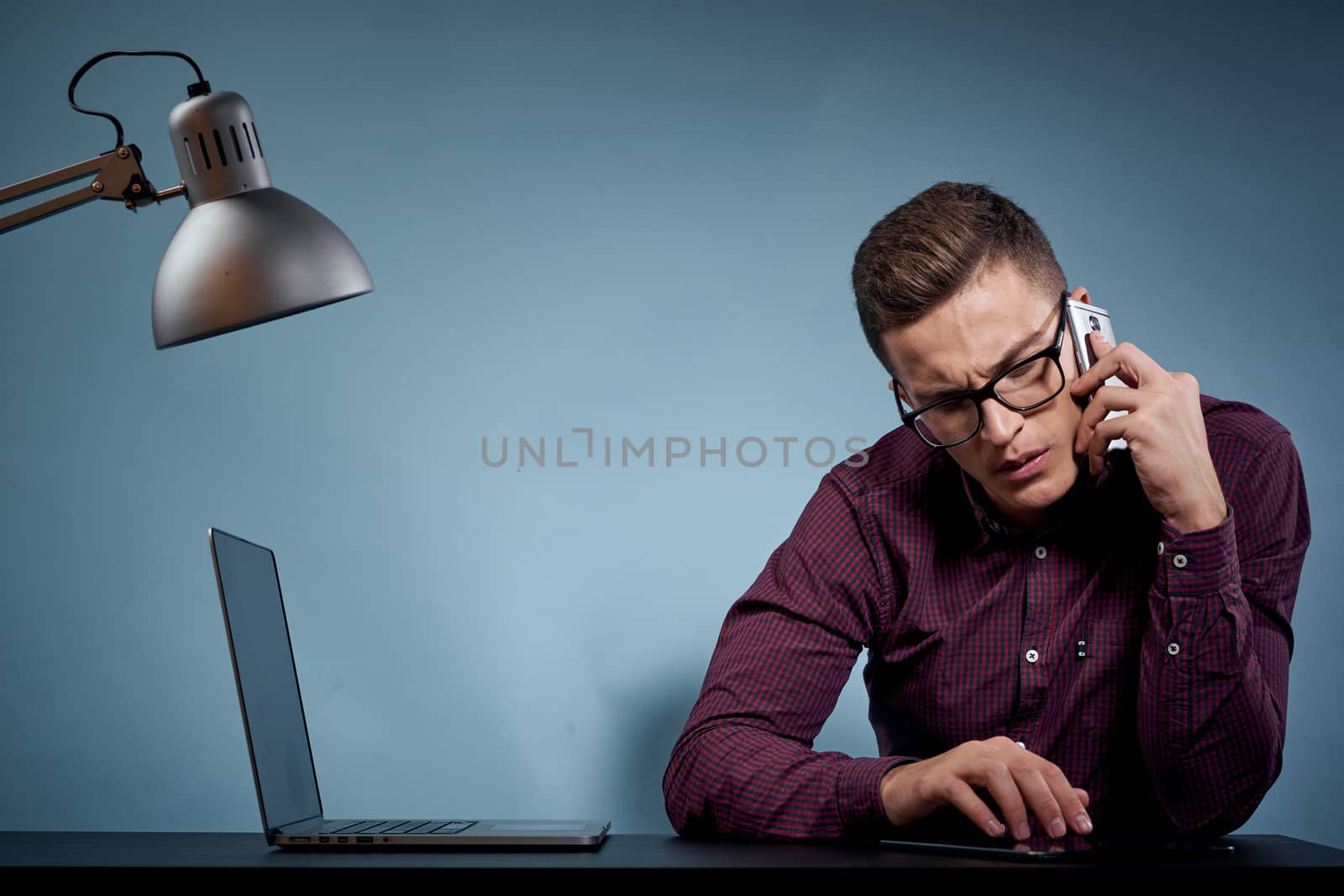 Business man talking on the phone in the office open laptop manager communication model. High quality photo